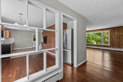 wooden floor in an empty room with a window