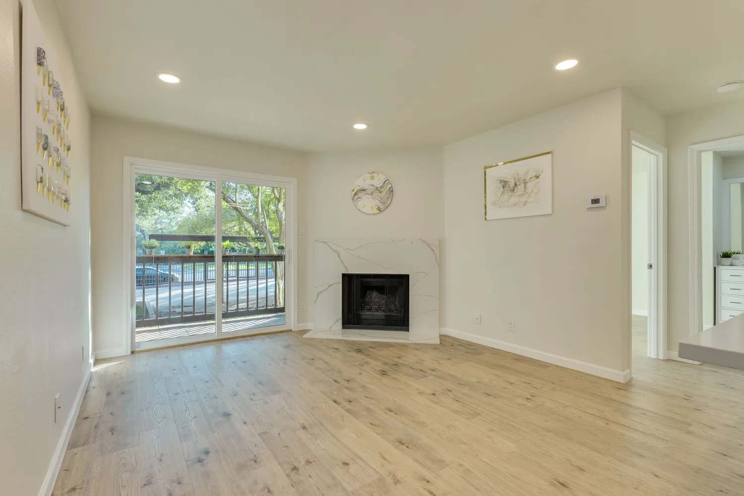 a view of an empty room with a fireplace and a window