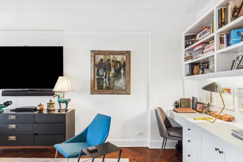 a workspace with furniture and a flat screen tv