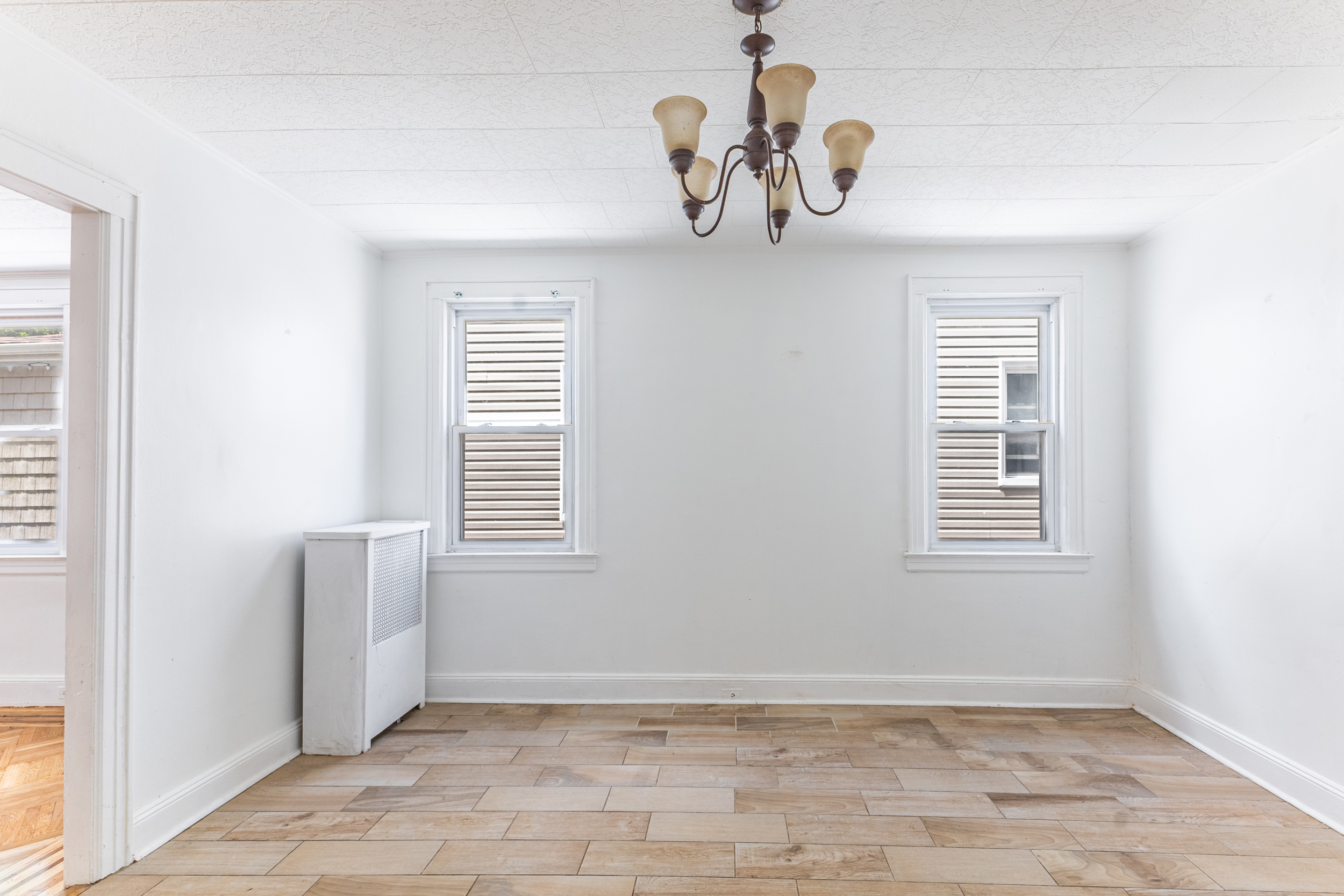 69-29 67th Place Queens, NY 11385 - Photo 10 of 24 a view of an empty room with a window