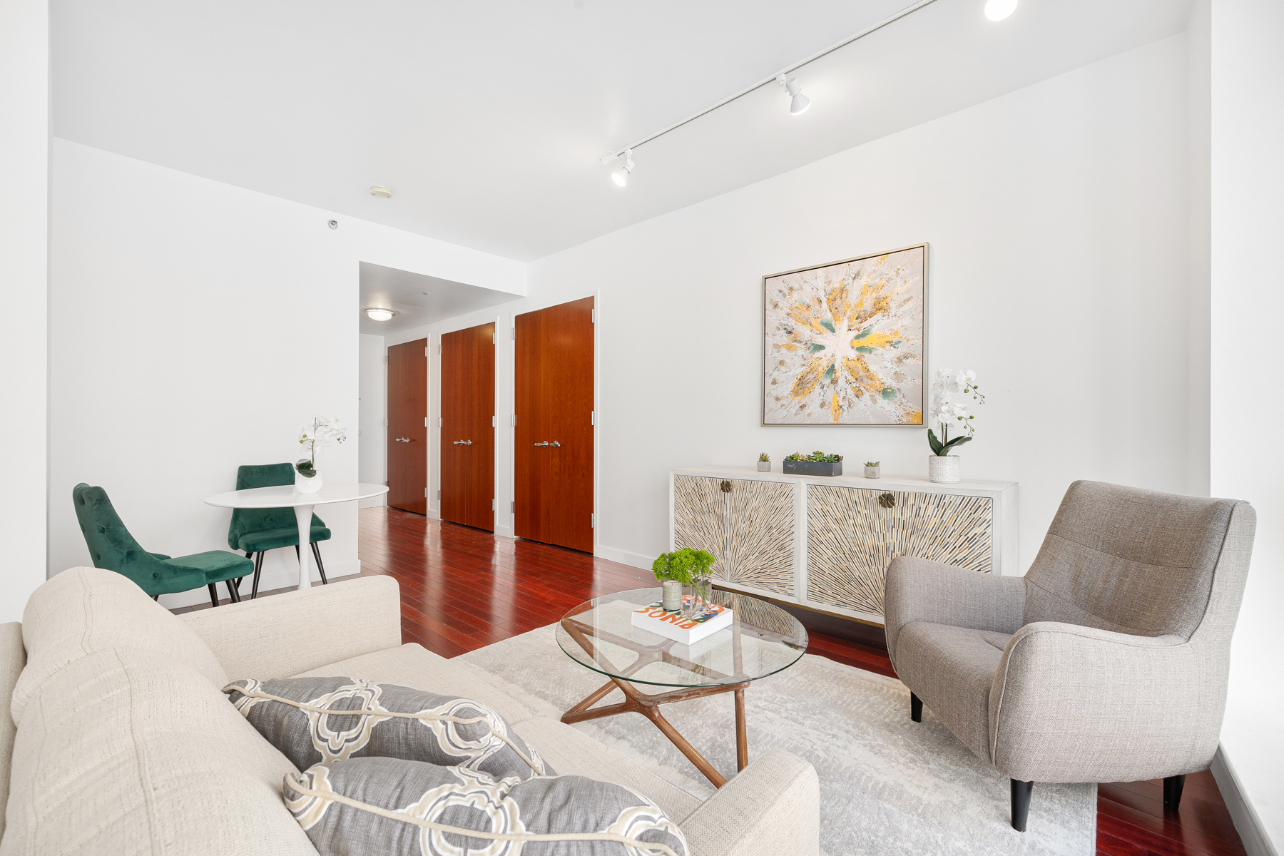 125 West 21st Street, Unit 4C Manhattan, NY 10011 - Photo 3 of 12 a living room with furniture and wooden floor