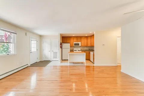 a view of a kitchen with wooden floor