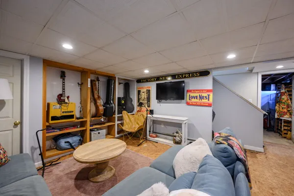 a bedroom with furniture and a flat screen tv