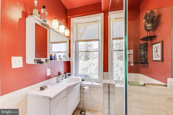 a bathroom with a sink vanity and a mirror
