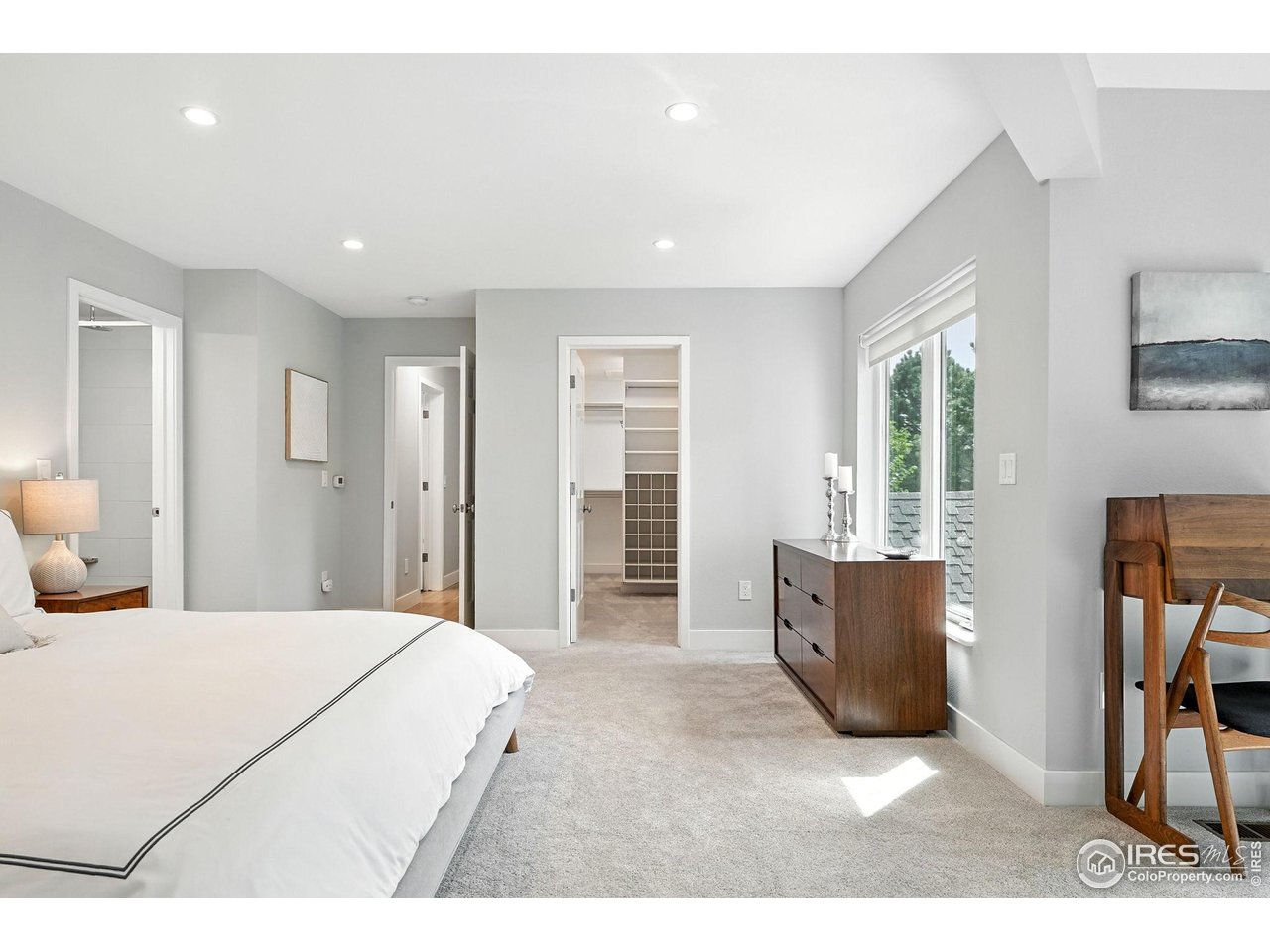 4557 Apple Way Boulder, CO 80301 - Photo 32 of 50 a spacious bedroom with a large bed and wooden floor