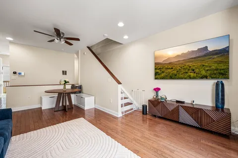 a living room with furniture and a wooden floor