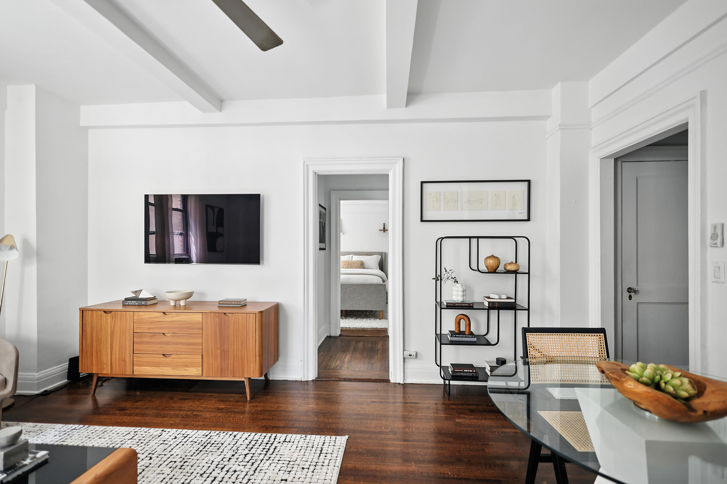 215 West 75th Street, Unit 6B Manhattan, NY 10023 - Photo 2 of 12 a living room with furniture and a wooden floor