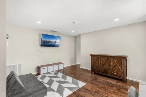 a bedroom with a bed and wooden floor