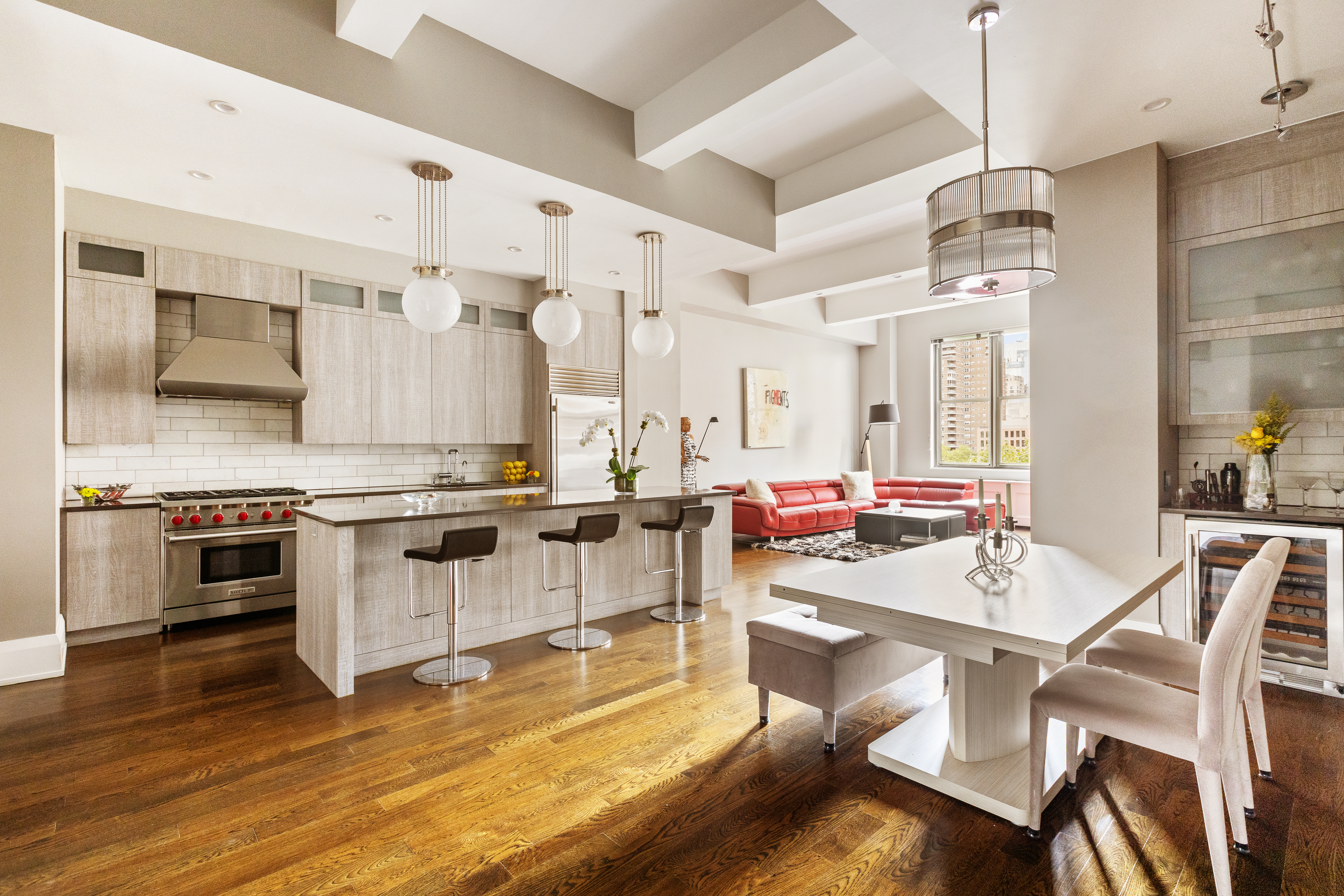 263 9th Avenue, Unit 5B Manhattan, NY 10001 - Photo 2 of 14 a kitchen with stainless steel appliances a stove a sink dishwasher and white cabinets with wooden floor