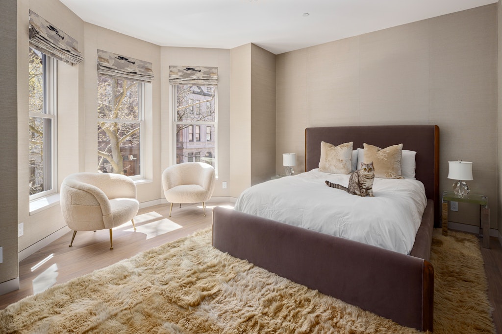 125 West 87th Street Manhattan, NY 10024 - Photo 14 of 27 a bedroom with a large bed and wooden floor