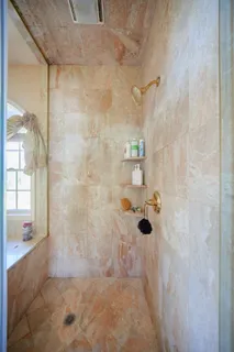 a view of walk in closet with clothes