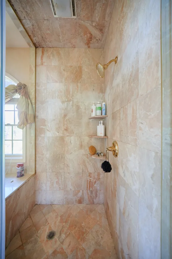 a view of walk in closet with clothes