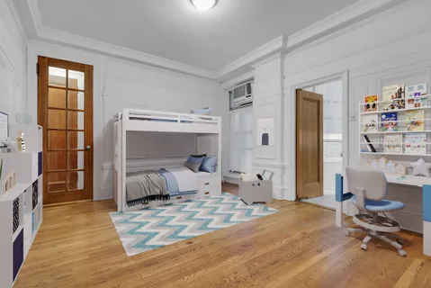 a bedroom with furniture and a window