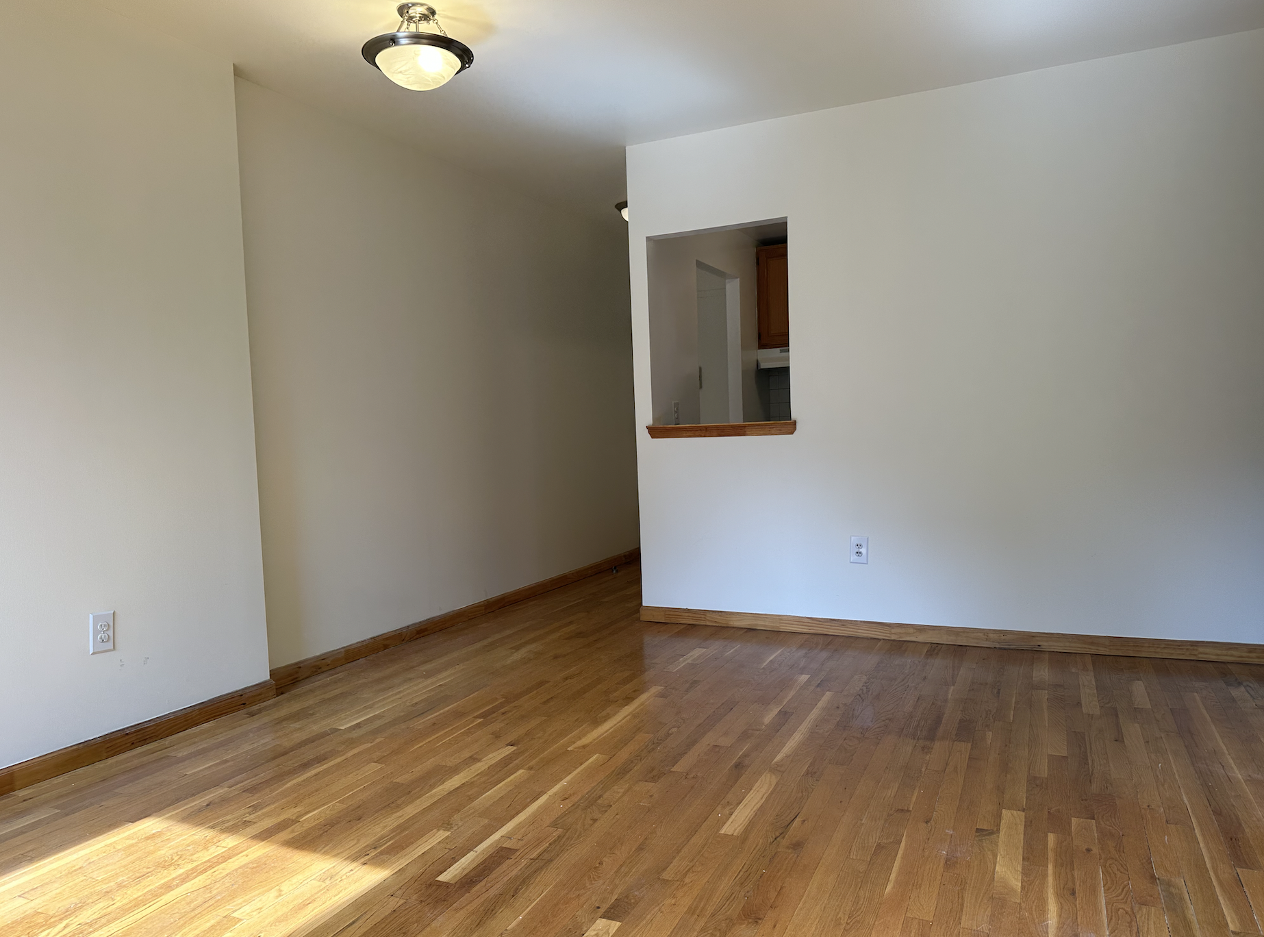 403 West 40th Street, Unit 2FE Manhattan, NY 10018 - Photo 4 of 12 a view of an empty room and wooden floor
