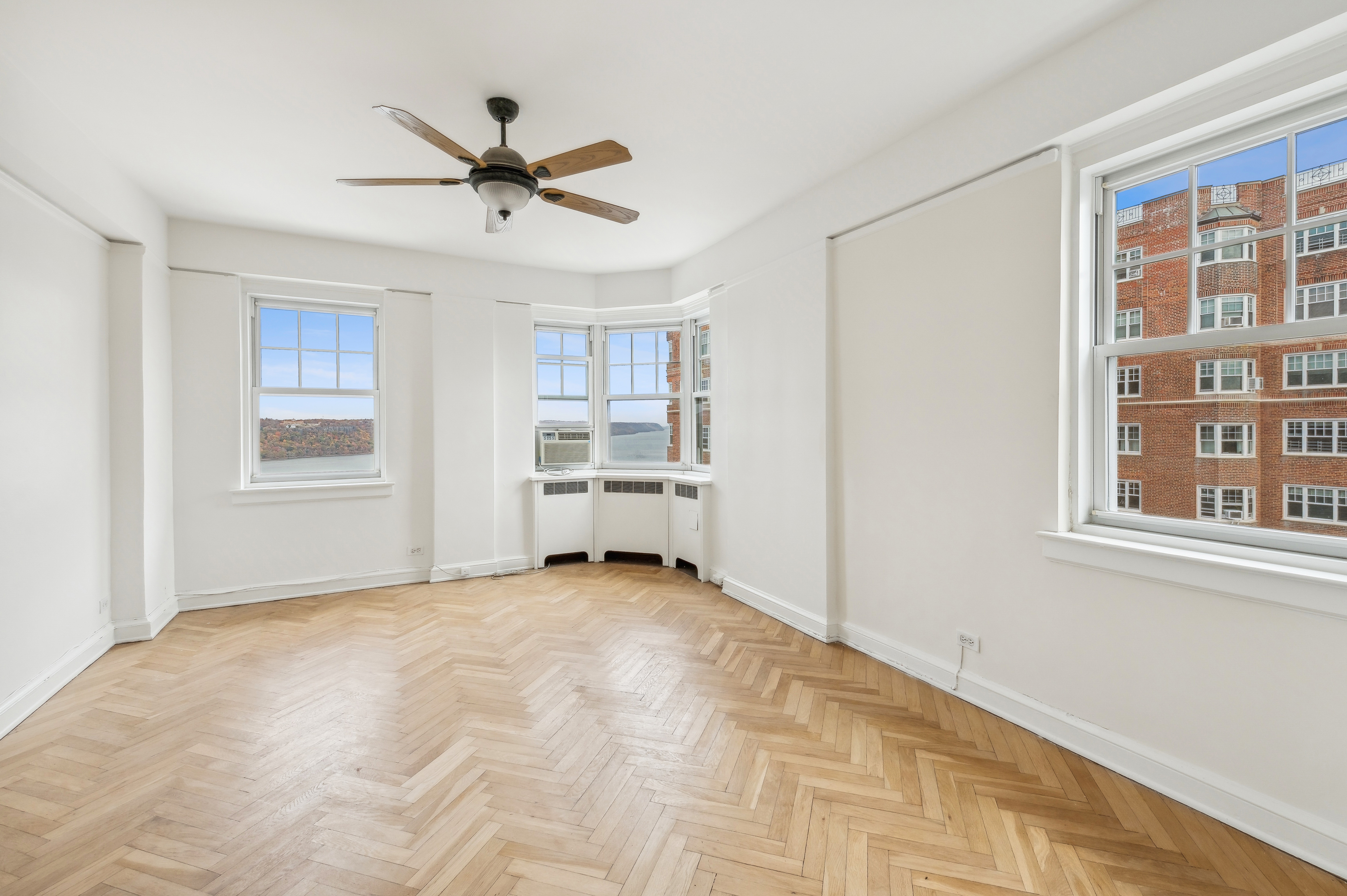 180 Cabrini Boulevard, Unit 98 Manhattan, NY 10033 - Photo 4 of 7 a view of a livingroom with a ceiling fan and window