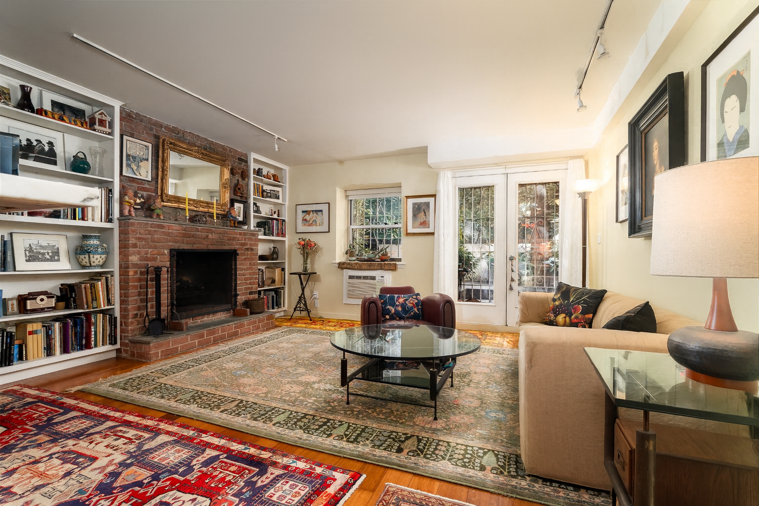 a living room with fireplace furniture and a rug