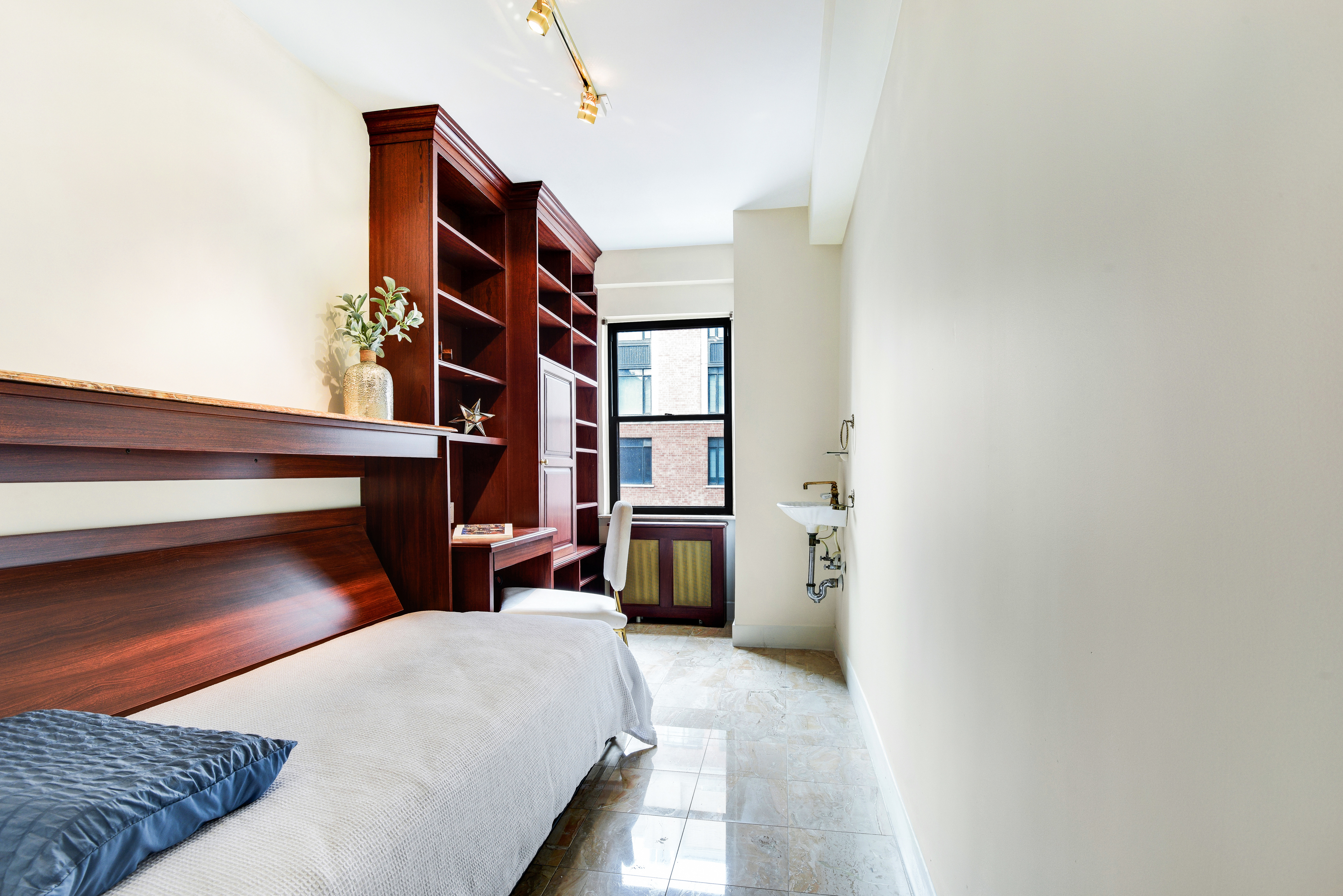49 East 96th Street, Unit 8/9E Manhattan, NY 10128 - Photo 11 of 17 a bedroom with a bed and a cabinets