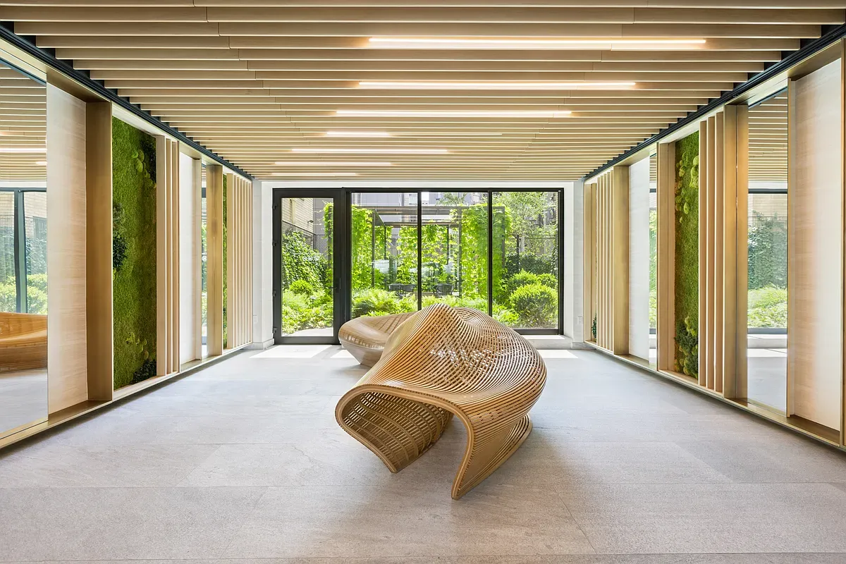a living room with furniture and floor to ceiling windows