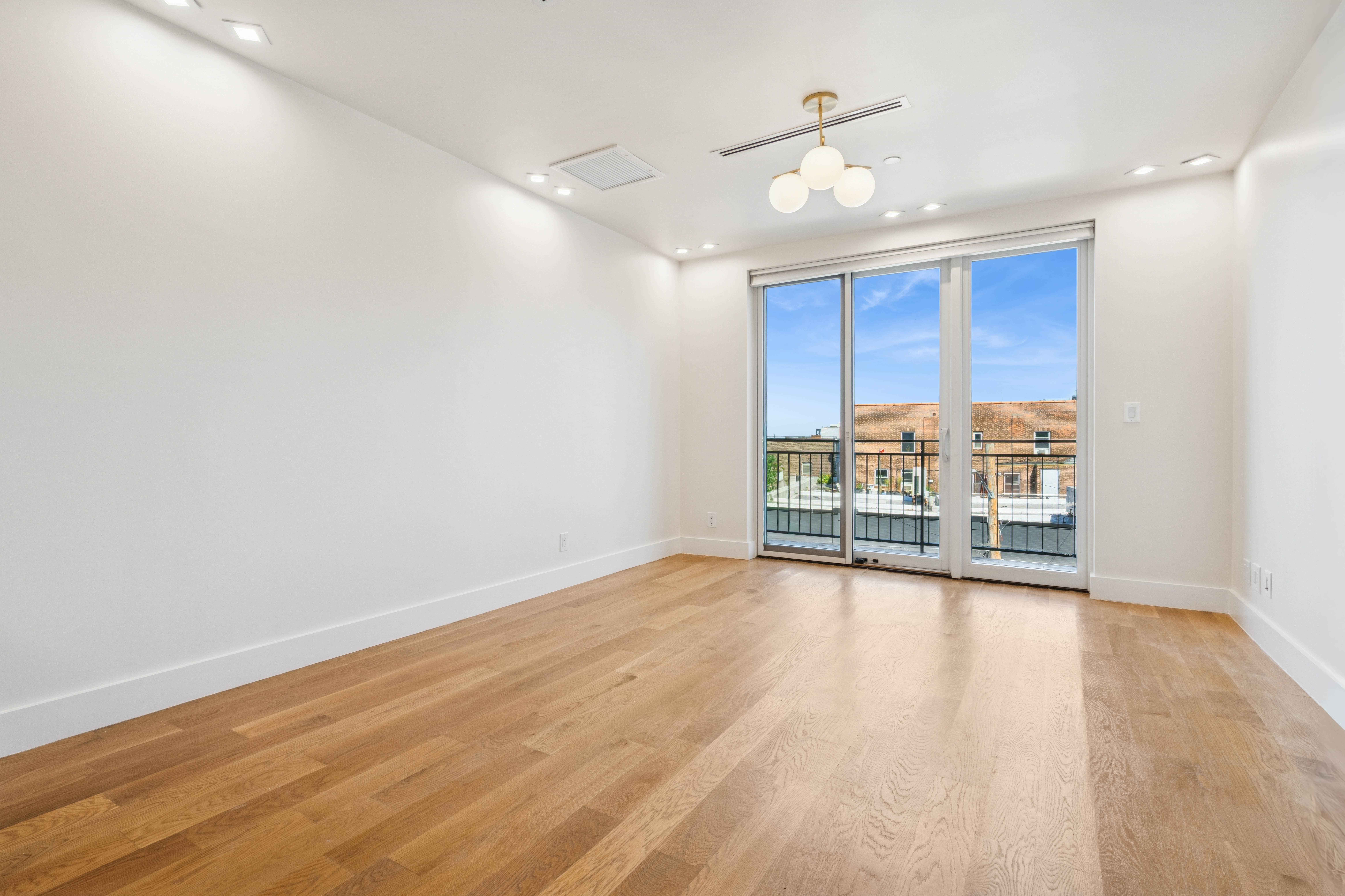 77 Kingsland Avenue, Unit 4F Brooklyn, NY 11211 - Photo 2 of 14 an empty room with wooden floor and windows