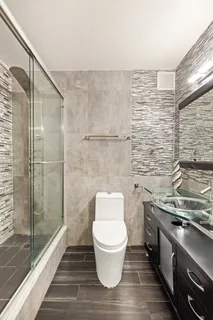 a bathroom with a toilet and a shower