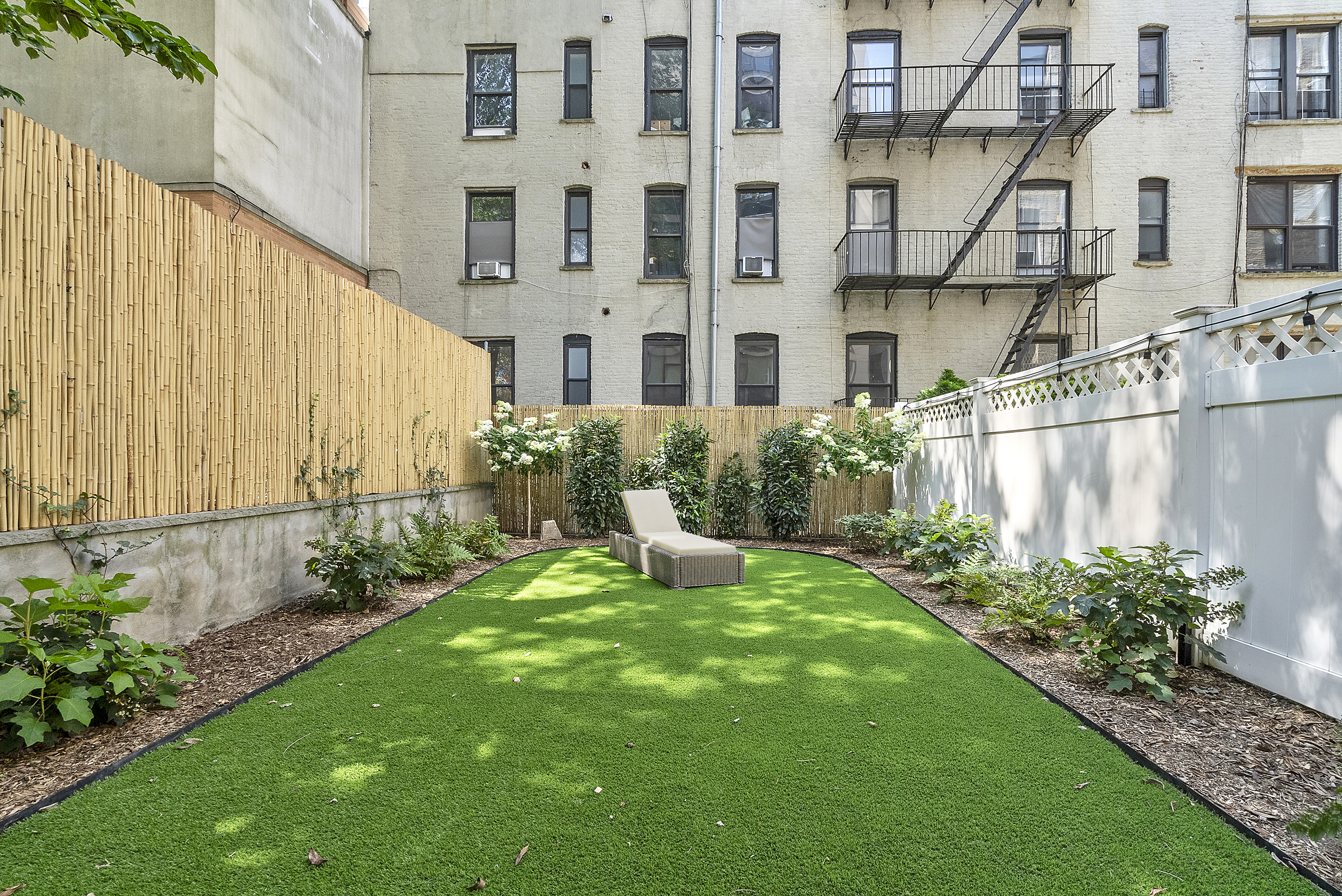 306 West 116th Street, Unit 1B Manhattan, NY 10026 - Photo 5 of 14 a view of a garden with a fountain