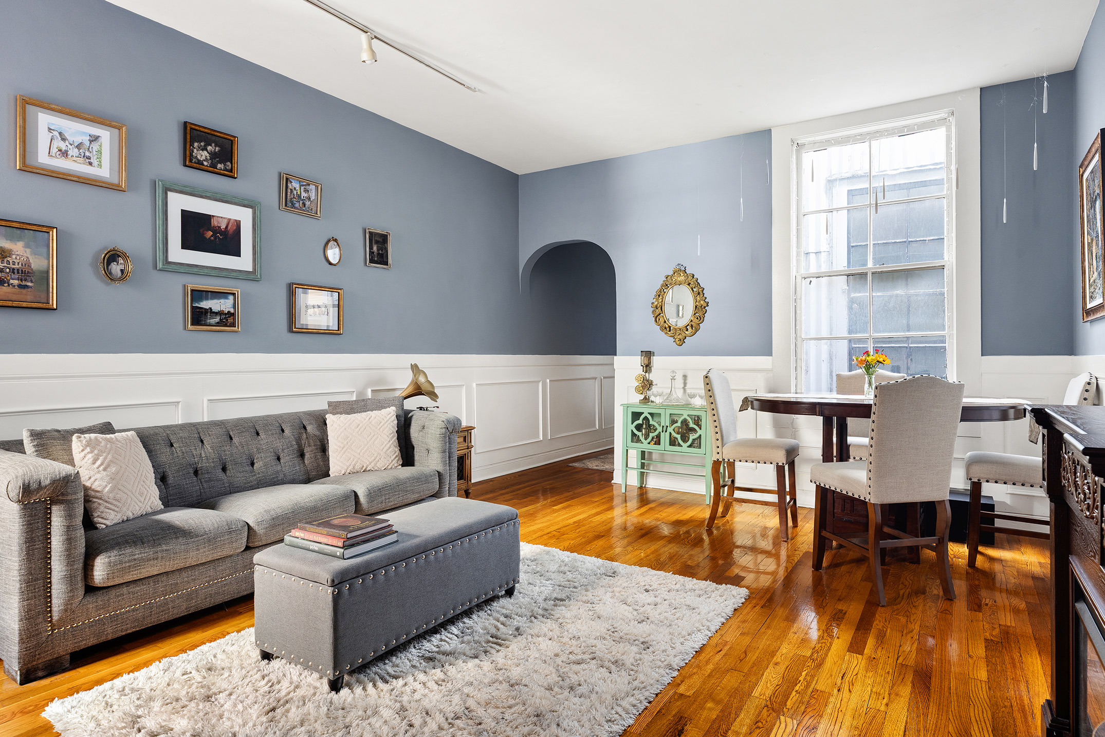 175 East 93rd Street, Unit 3B Manhattan, NY 10128 - Photo 4 of 12 a living room with furniture and wooden floor