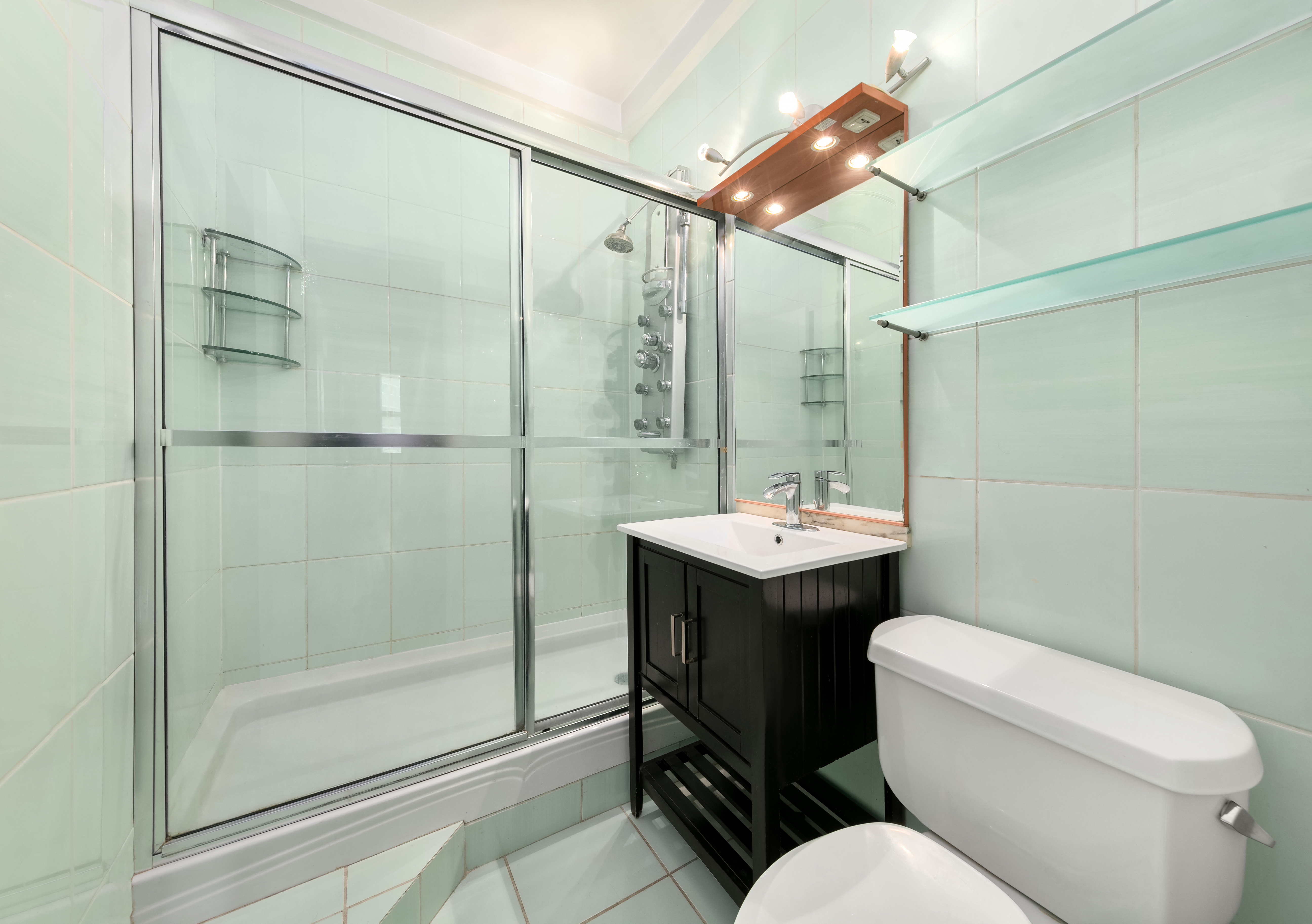 3 Hanover Square, Unit 10H Manhattan, NY 10004 - Photo 7 of 9 a bathroom with a sink toilet and shower