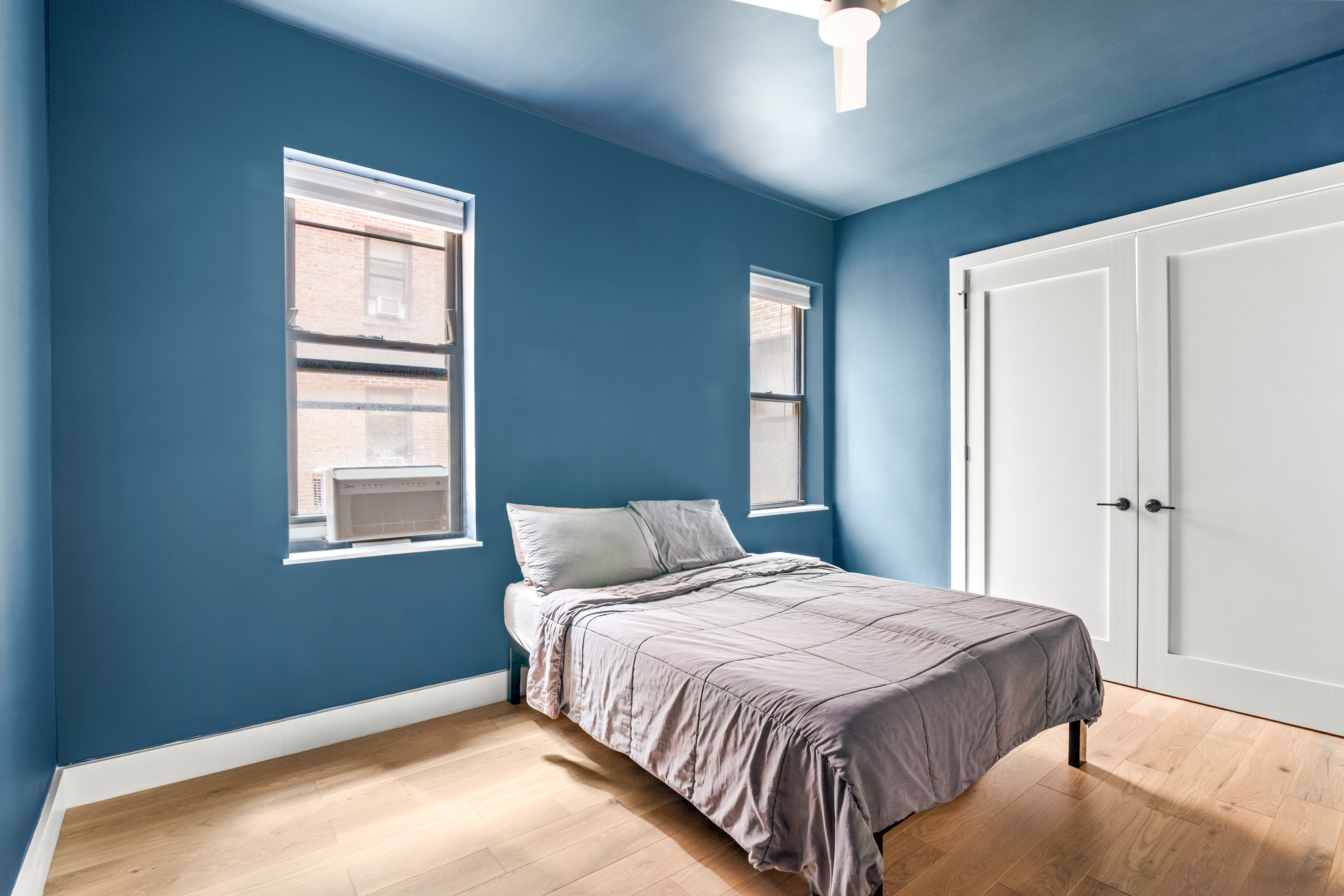 170 East 94th Street, Unit 1C Manhattan, NY 10128 - Photo 4 of 9 a bedroom with a bed and a window