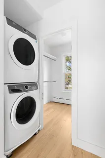 a view of a hallway with washer and dryer