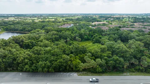 an aerial view of a house with yard and lake view