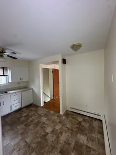 a bathroom with a sink a toilet a mirror and tub