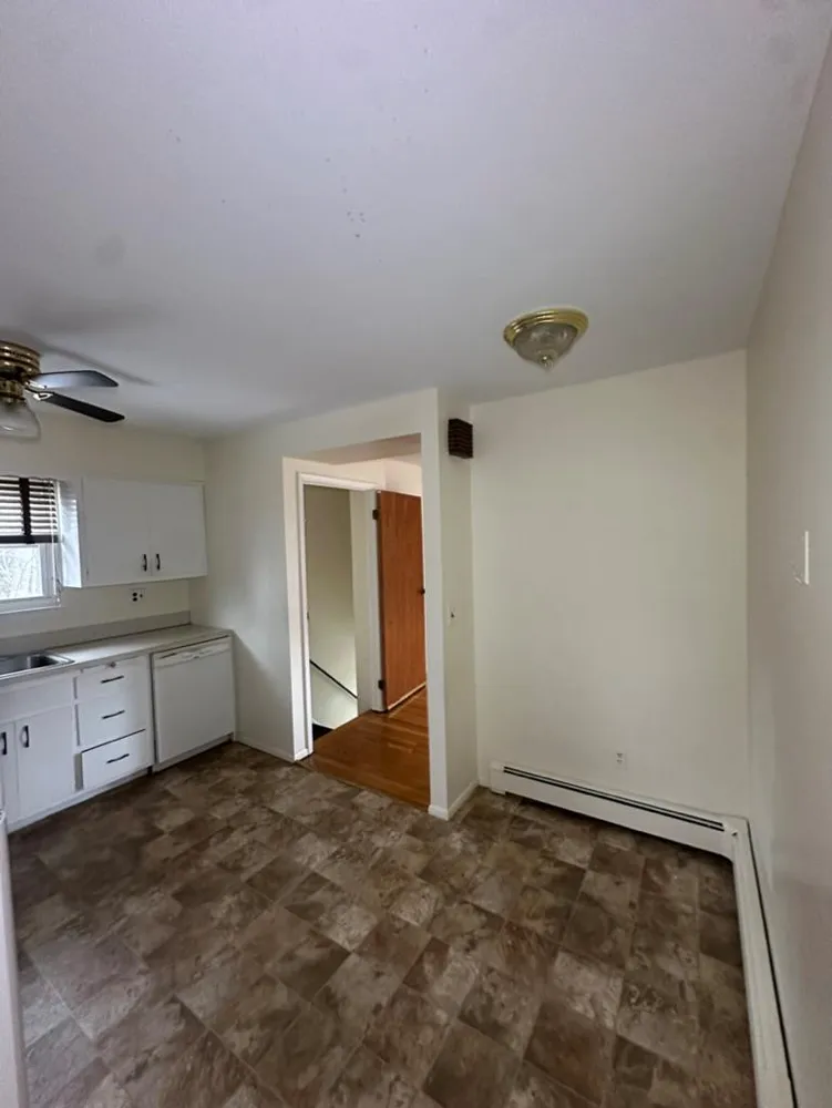 a bathroom with a sink a toilet a mirror and tub