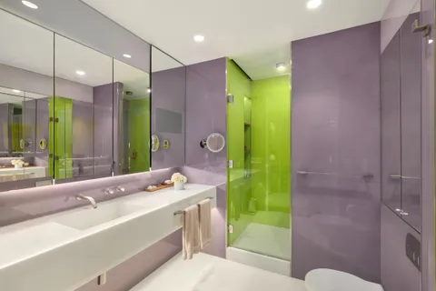 a bathroom with a sink mirror and a shower