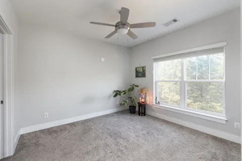 a view of room with window and ceiling fan