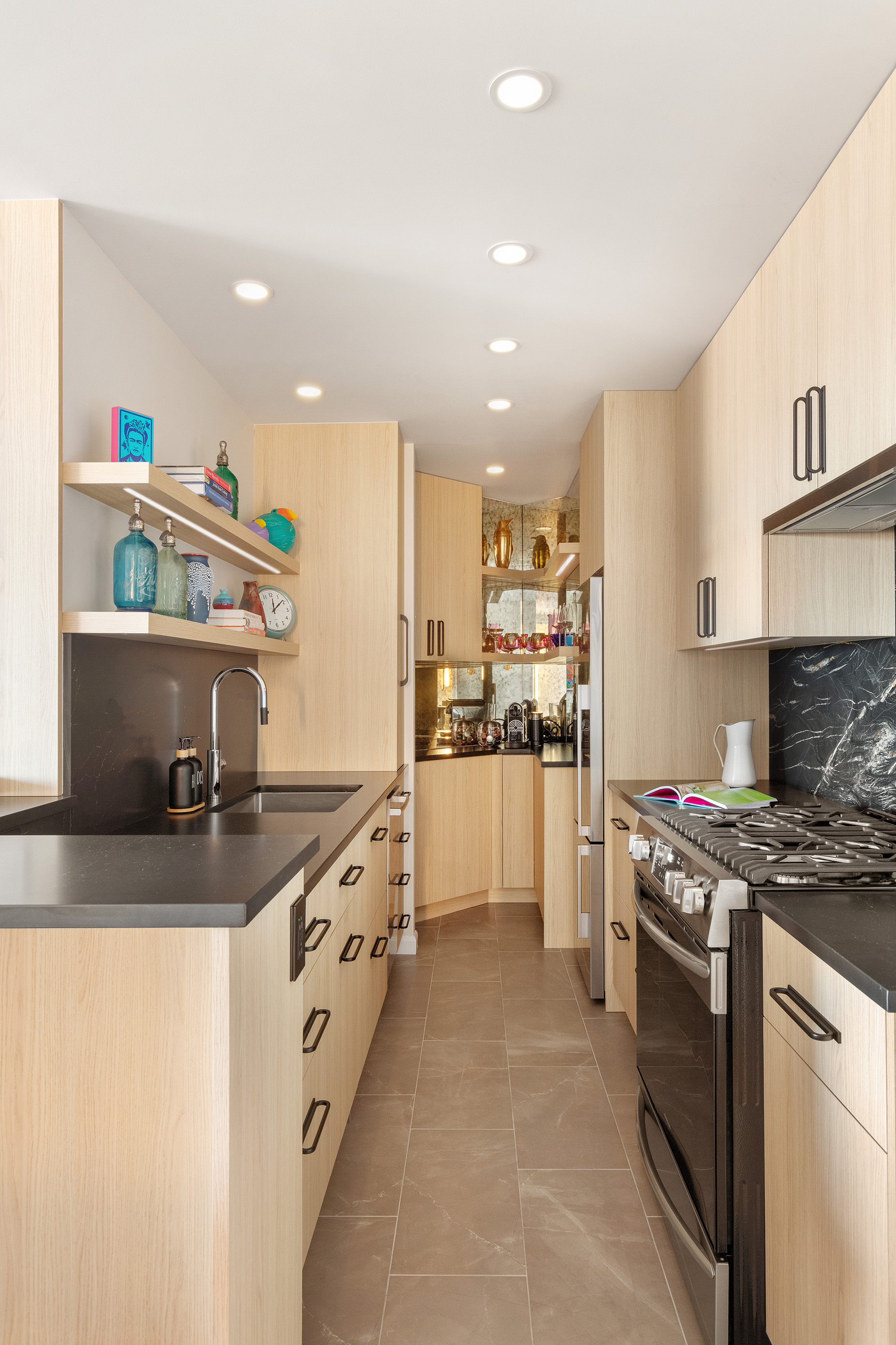 225 West 83rd Street, Unit 19A Manhattan, NY 10024 - Photo 4 of 15 a kitchen with stainless steel appliances granite countertop a sink stove and refrigerator