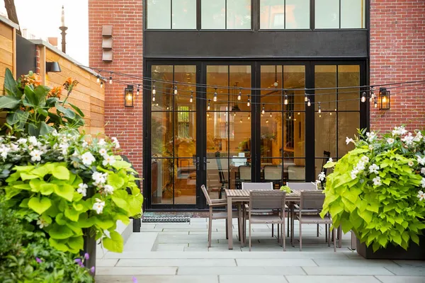 a view of balcony with chairs and potted plants