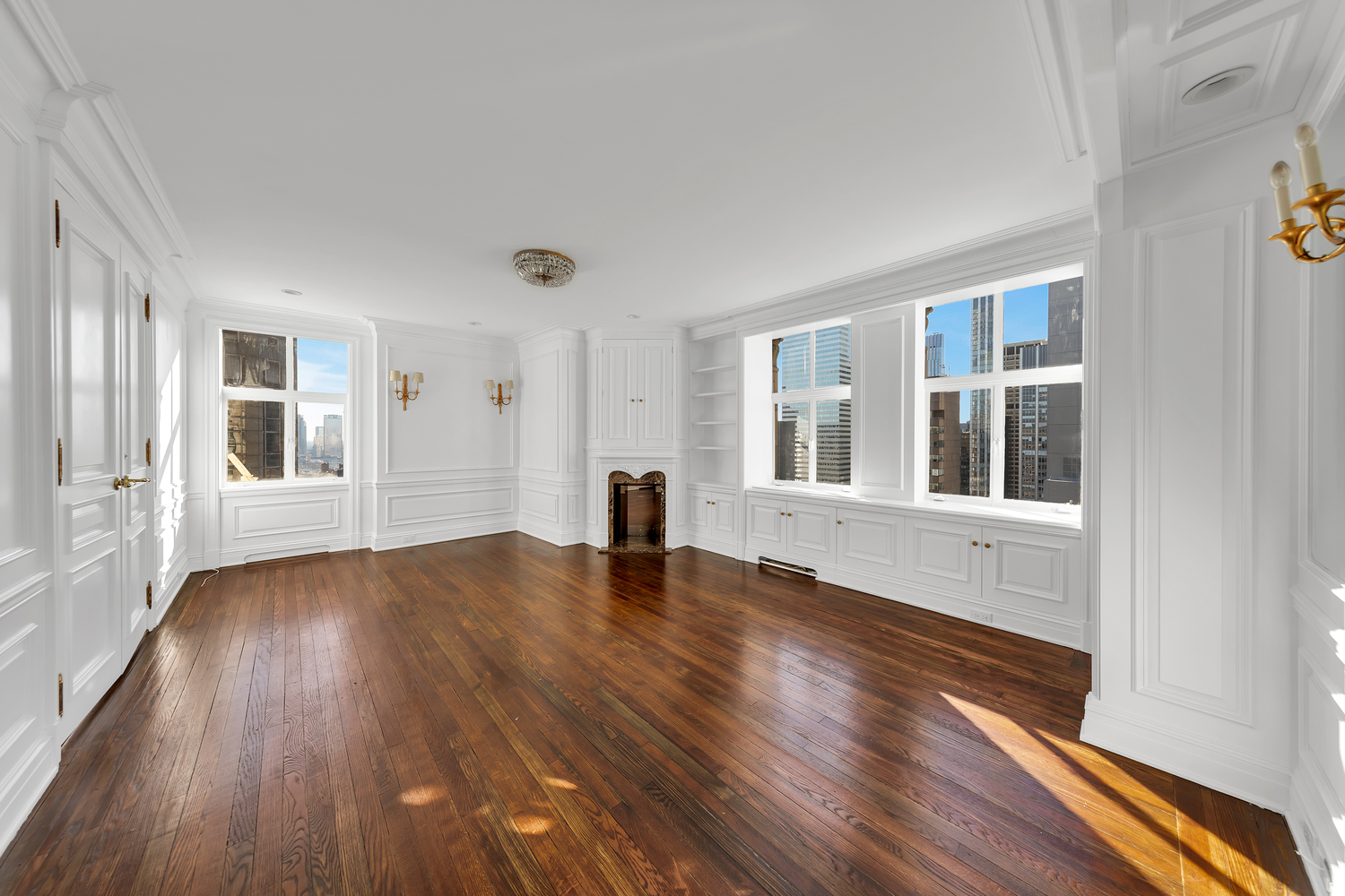 465 Park Avenue, Unit 34E Manhattan, NY 10022 - Photo 9 of 18 a view of an empty room with wooden floor and a window