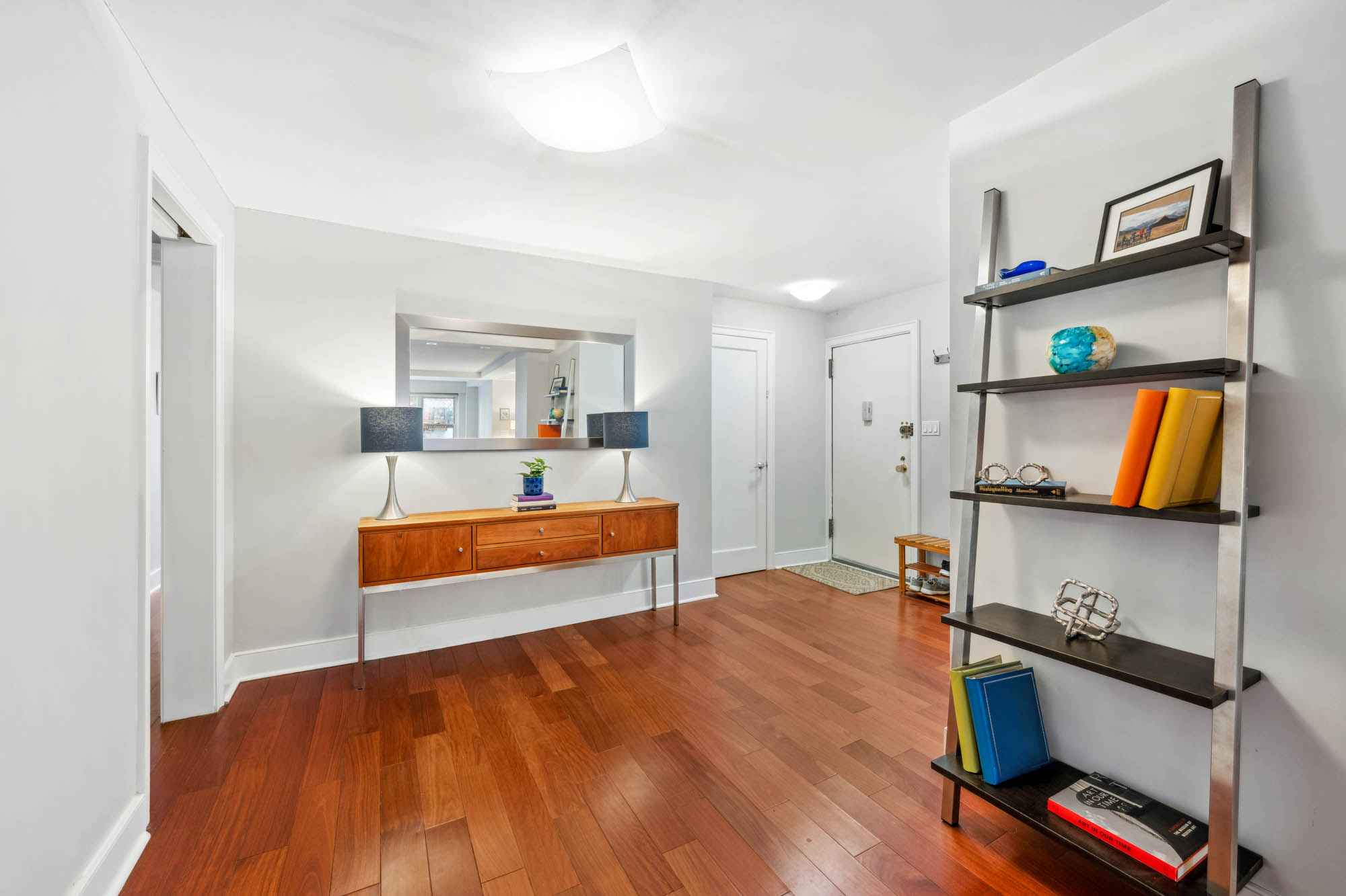 420 East 72nd Street, Unit 2J Manhattan, NY 10021 - Photo 5 of 12 a bedroom with a bed and a flat tv screen on the dresser