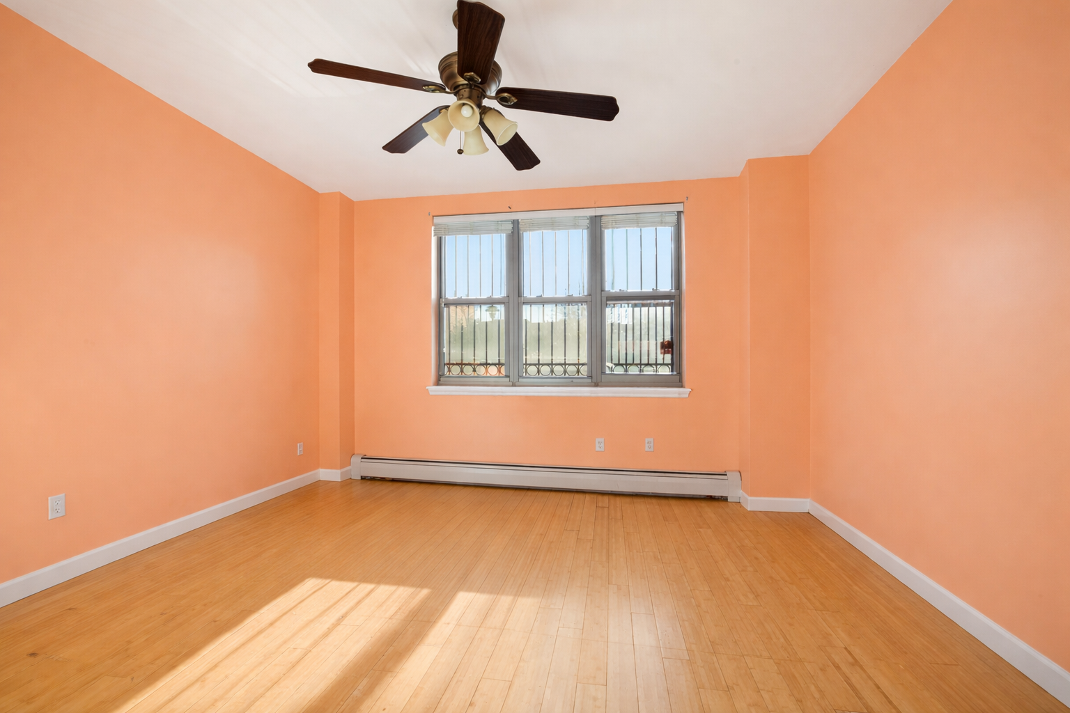 415 East 160th Street, Unit 1 Bronx, NY 10451 - Photo 6 of 16 an empty room with a window and a ceiling fan