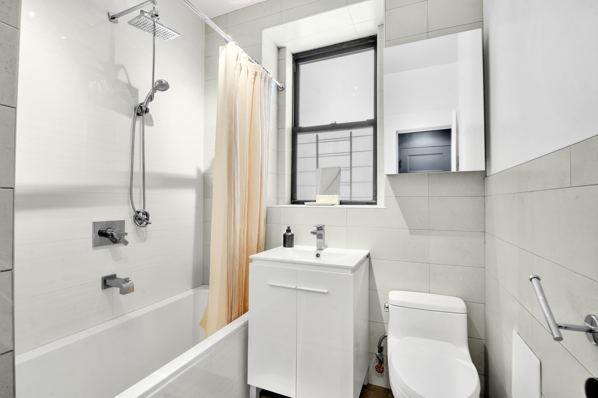 790 Riverside Drive, Unit 2LX Manhattan, NY 10032 - Photo 7 of 10 a bathroom with a toilet sink and mirror