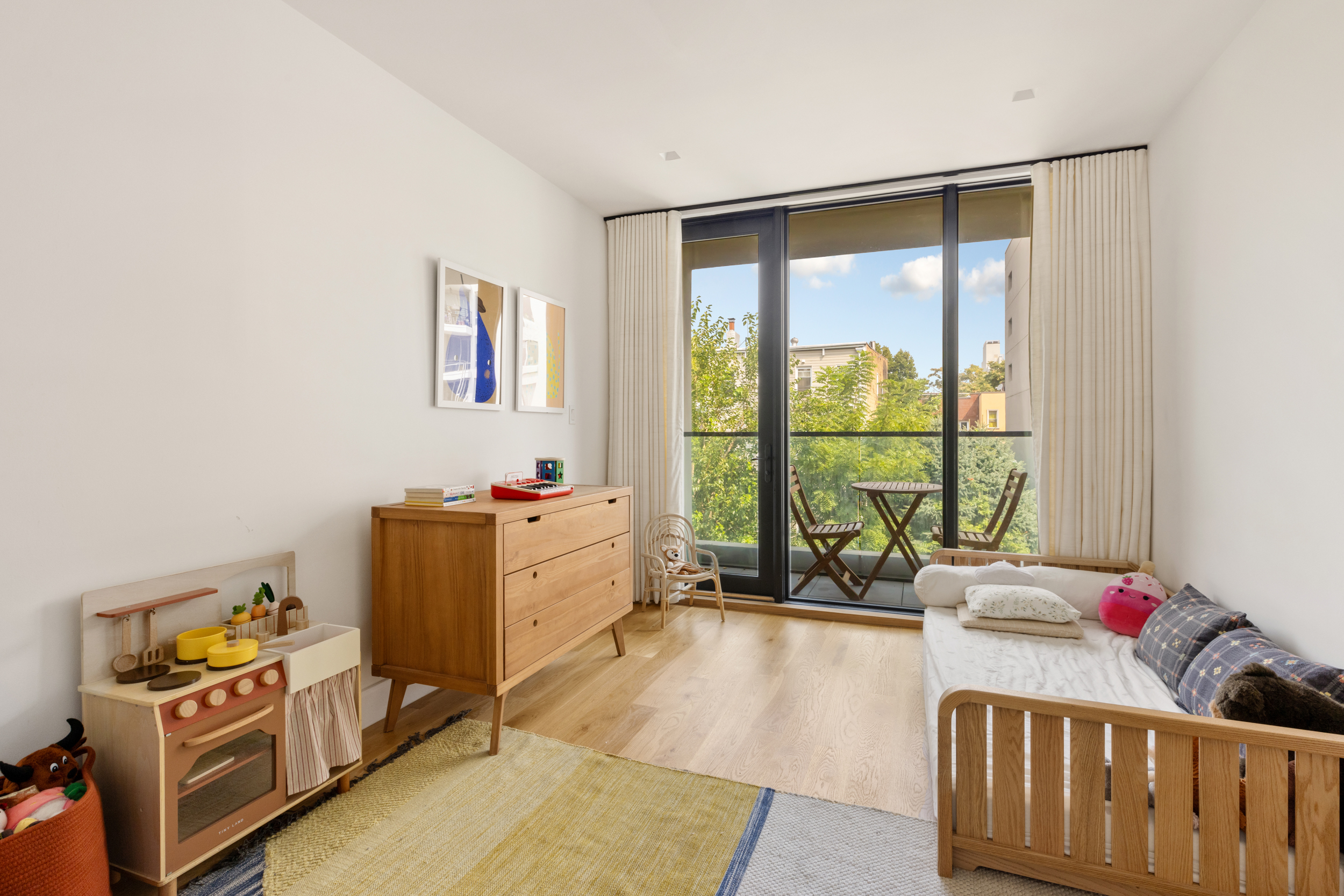 205 Freeman Street, Unit 3 Brooklyn, NY 11222 - Photo 6 of 9 a bedroom with furniture and a large window