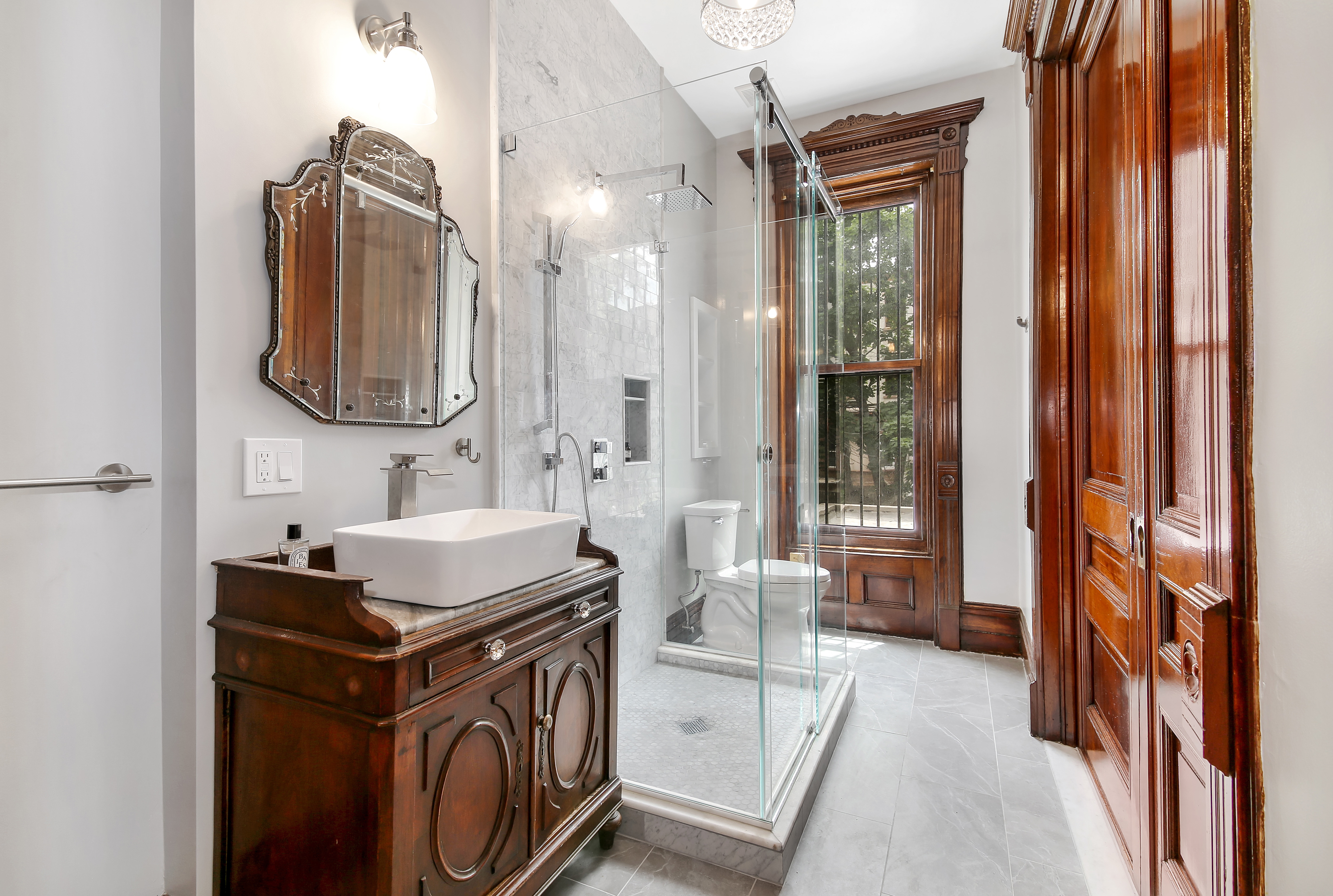 666 Putnam Avenue, Unit 1 Brooklyn, NY 11221 - Photo 6 of 8 a bathroom with a sink a toilet and shower