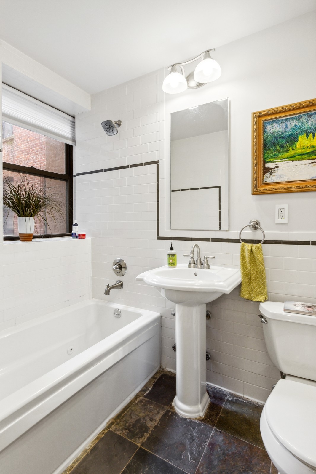 250 Manhattan Avenue, Unit 3A Manhattan, NY 10026 - Photo 9 of 15 a bathroom with a sink a mirror and a toilet