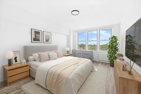 a spacious bedroom with a bed and a couch