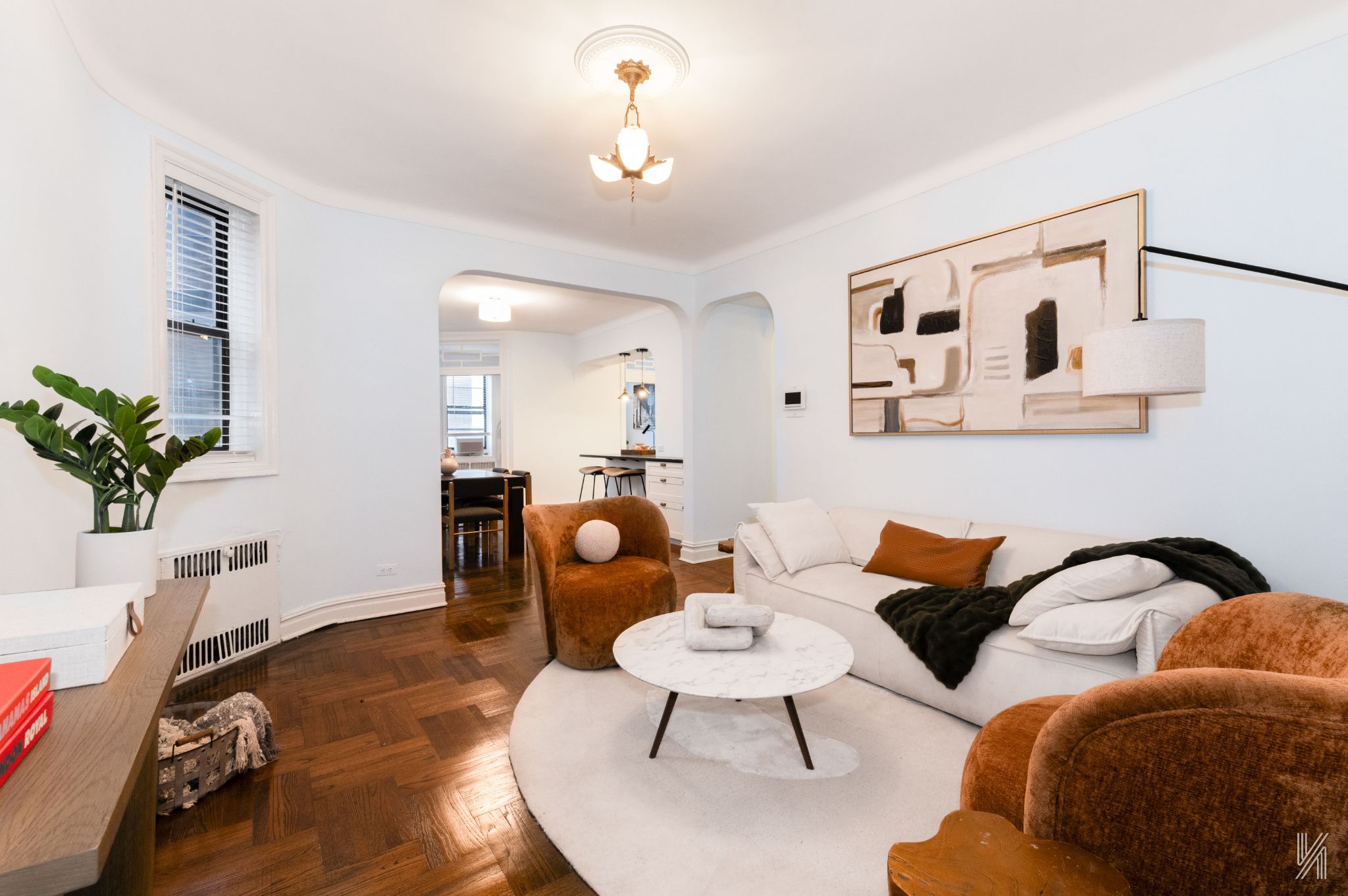 35-06 88th Street, Unit 5E Queens, NY 11372 - Photo 2 of 21 a living room with furniture and a potted plant