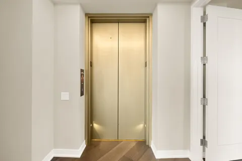 a living room with furniture and floor to ceiling windows