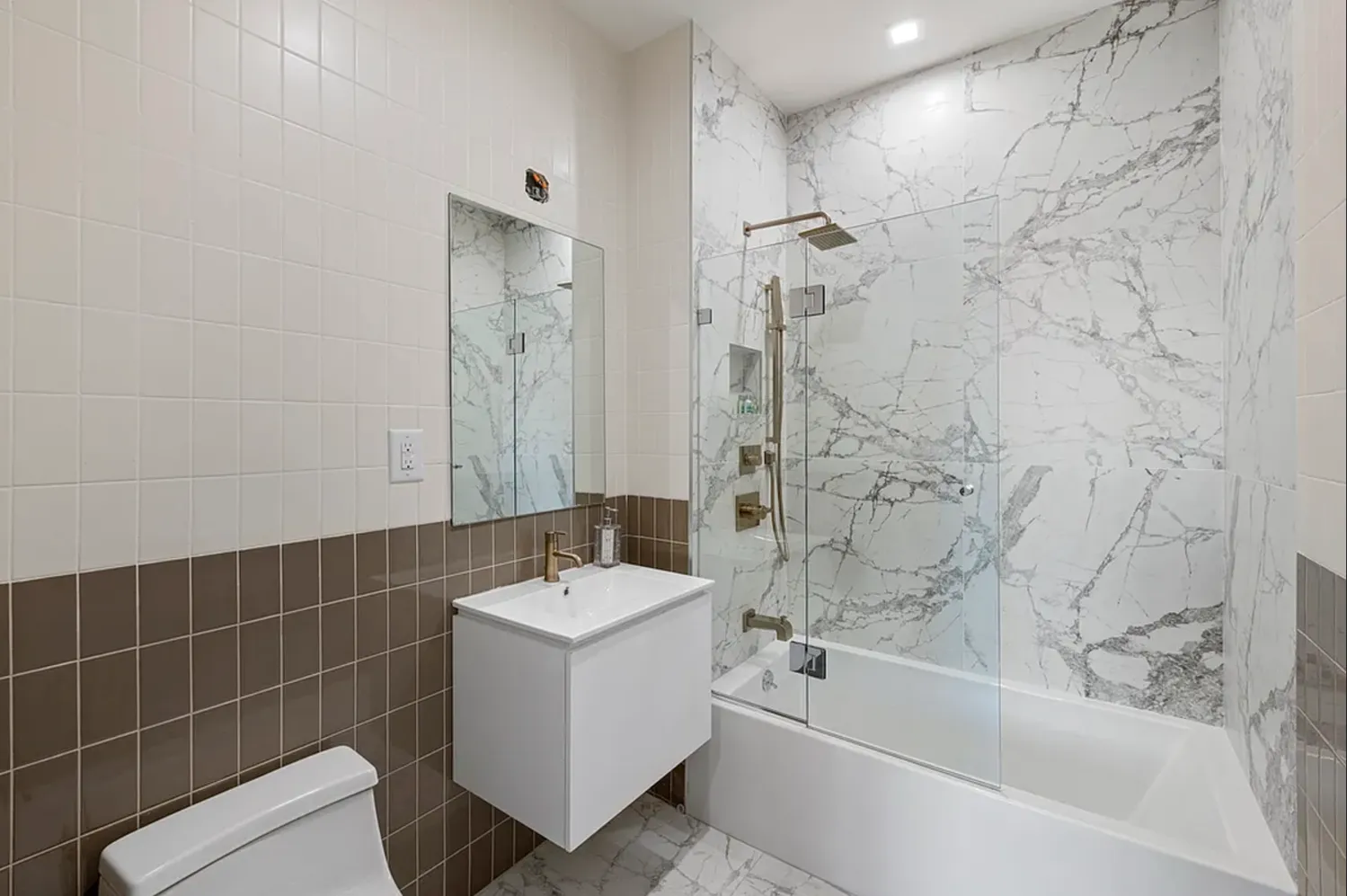 a bathroom with sink mirror bathtub and shower