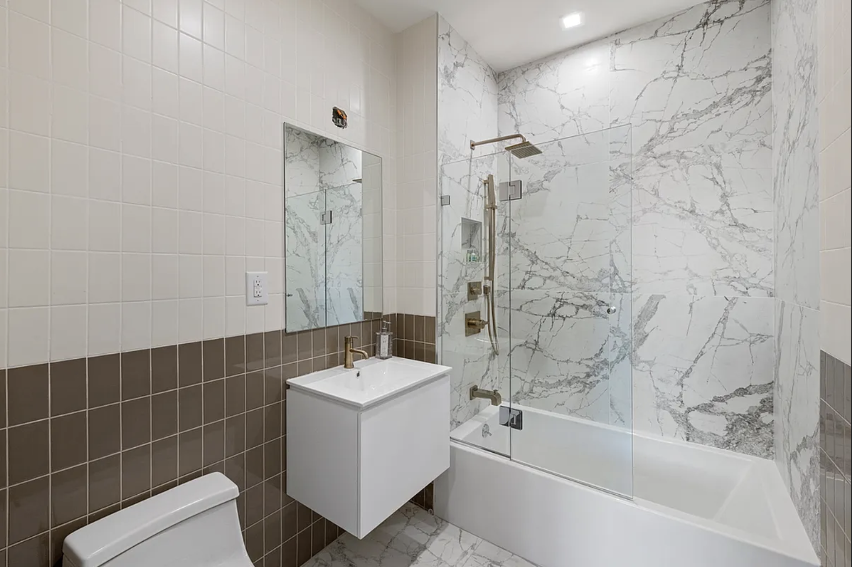 371 Lincoln Road, Unit 2 Brooklyn, NY 11225 - Photo 12 of 19 a bathroom with sink mirror bathtub and shower