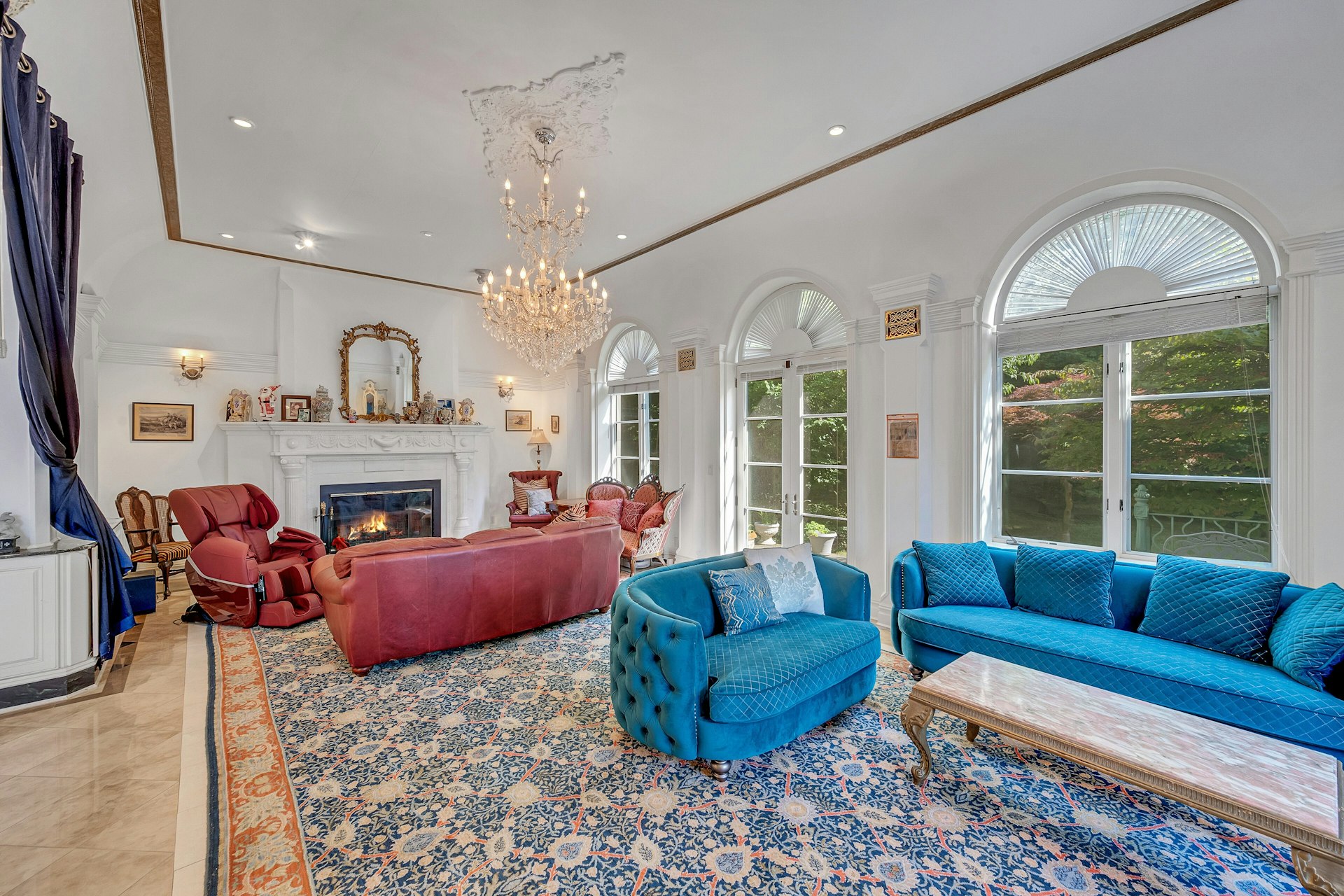 5440 Independence Avenue Bronx, NY 10471 - Photo 8 of 36 a living room with furniture a fireplace and a chandelier