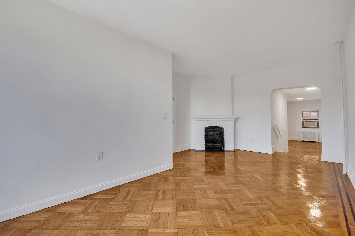 7001 Shore Road, Unit 2 Brooklyn, NY 11209 - Photo 2 of 17 a view of an empty room with a fireplace and a window